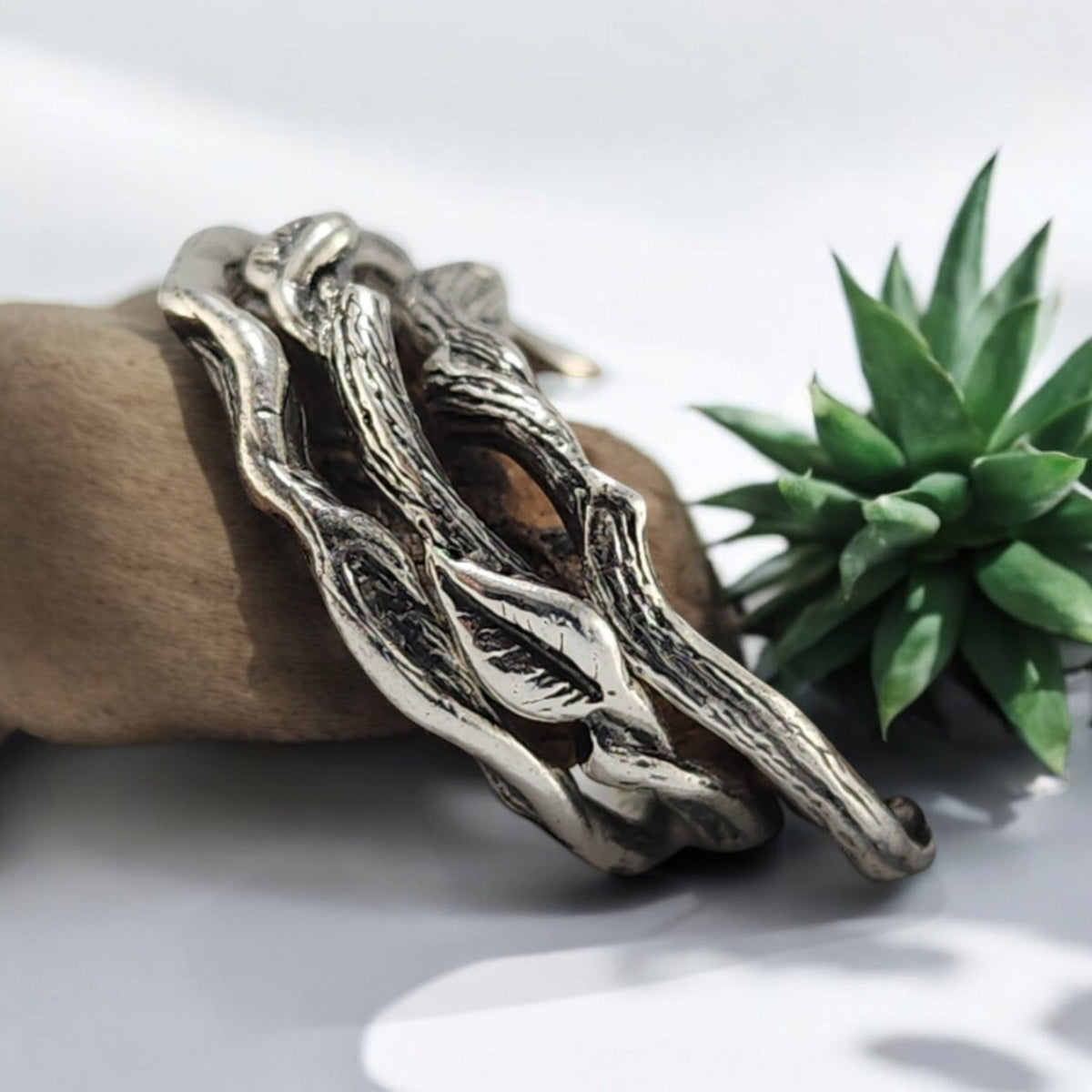 3 silver rings with vines and leaves locking together in a set of 3