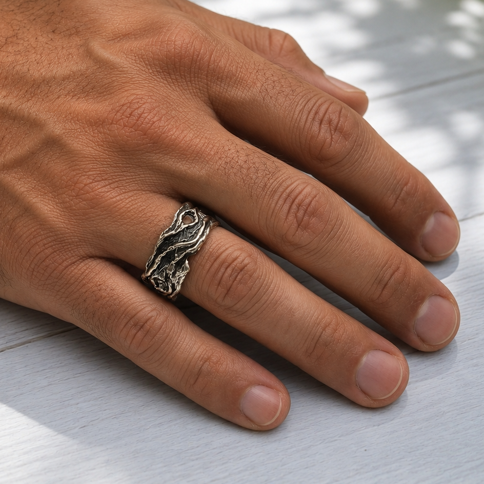 driftwood style sterling silver ring on a man's hand