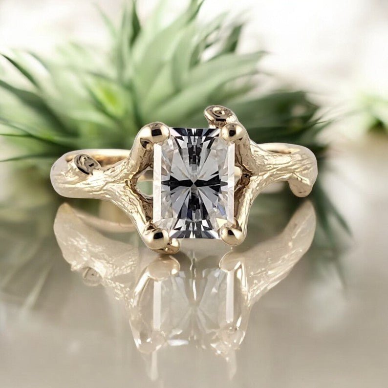 radiant cut moissanite diamond in a yellow gold twig style ring setting