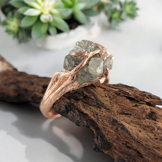 A one-of-a-kind engagement ring featuring a raw diamond set in a handcrafted twig branch band.