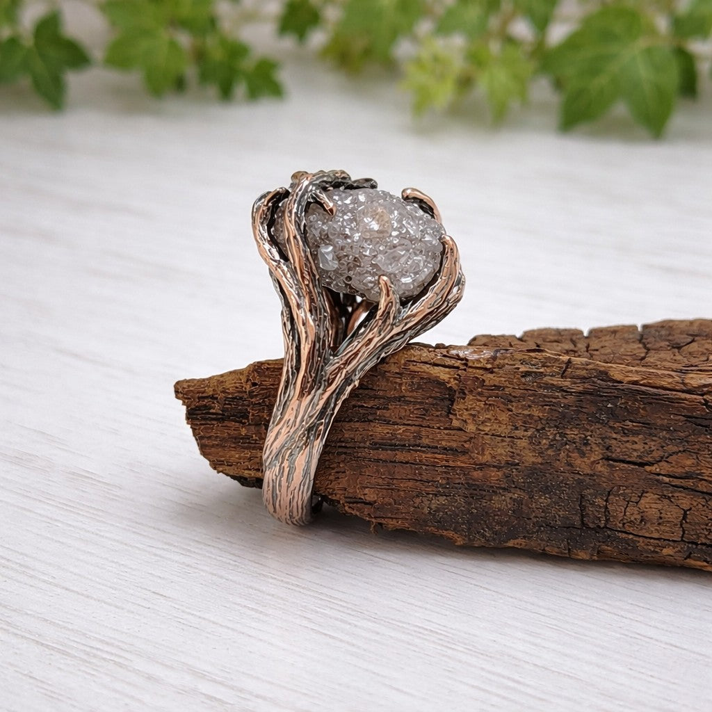 raw diamond twig engagement ring in rose gold on wood background