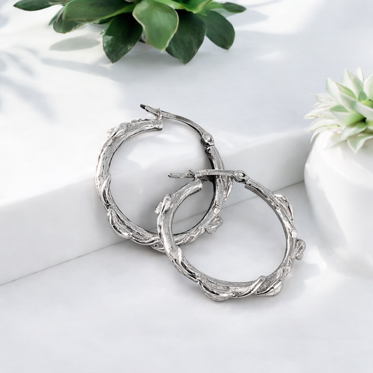 sterling silver hoop earrings with a delicate leaf designs all over