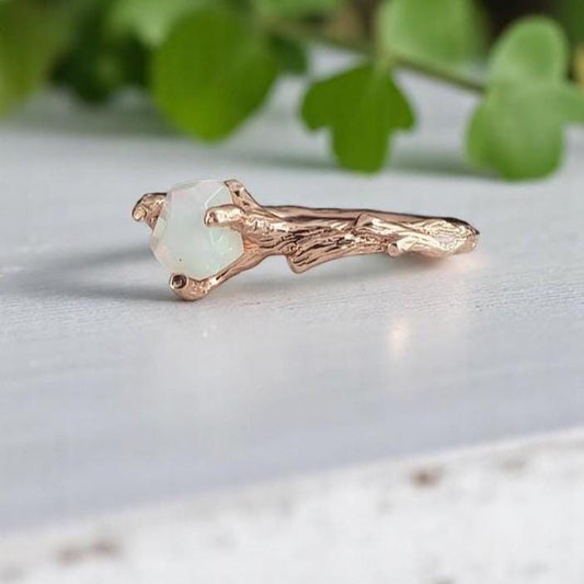 raw opal that's been hand-cut to fit in a solid gold twig ring setting
