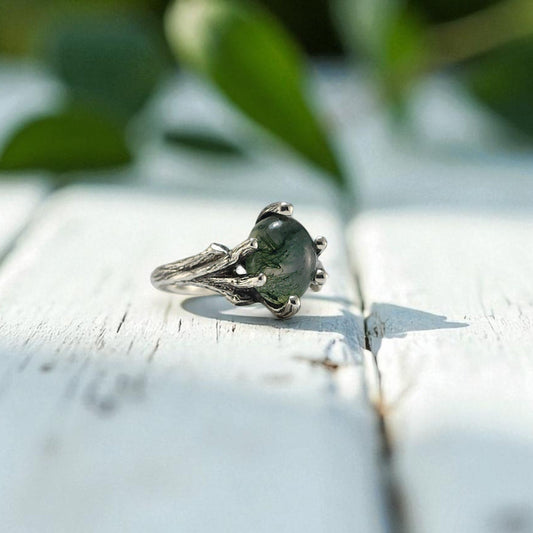 Sterling Silver ring with prongs holding an oval moss agate ring