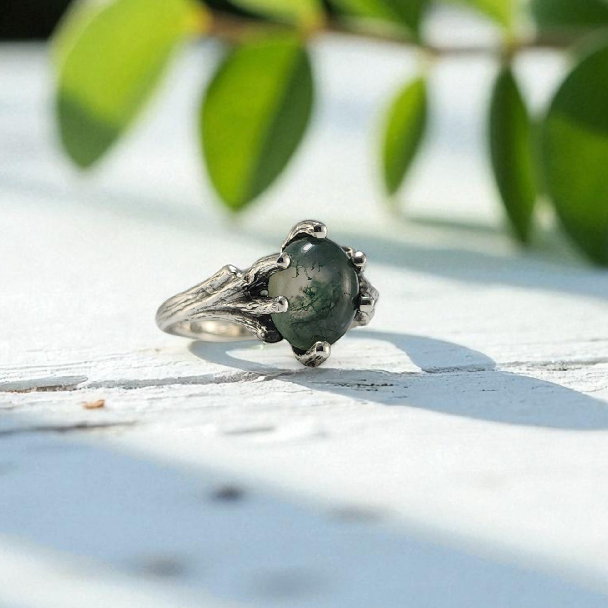 Sterling Silver ring with prongs holding an oval moss agate ring