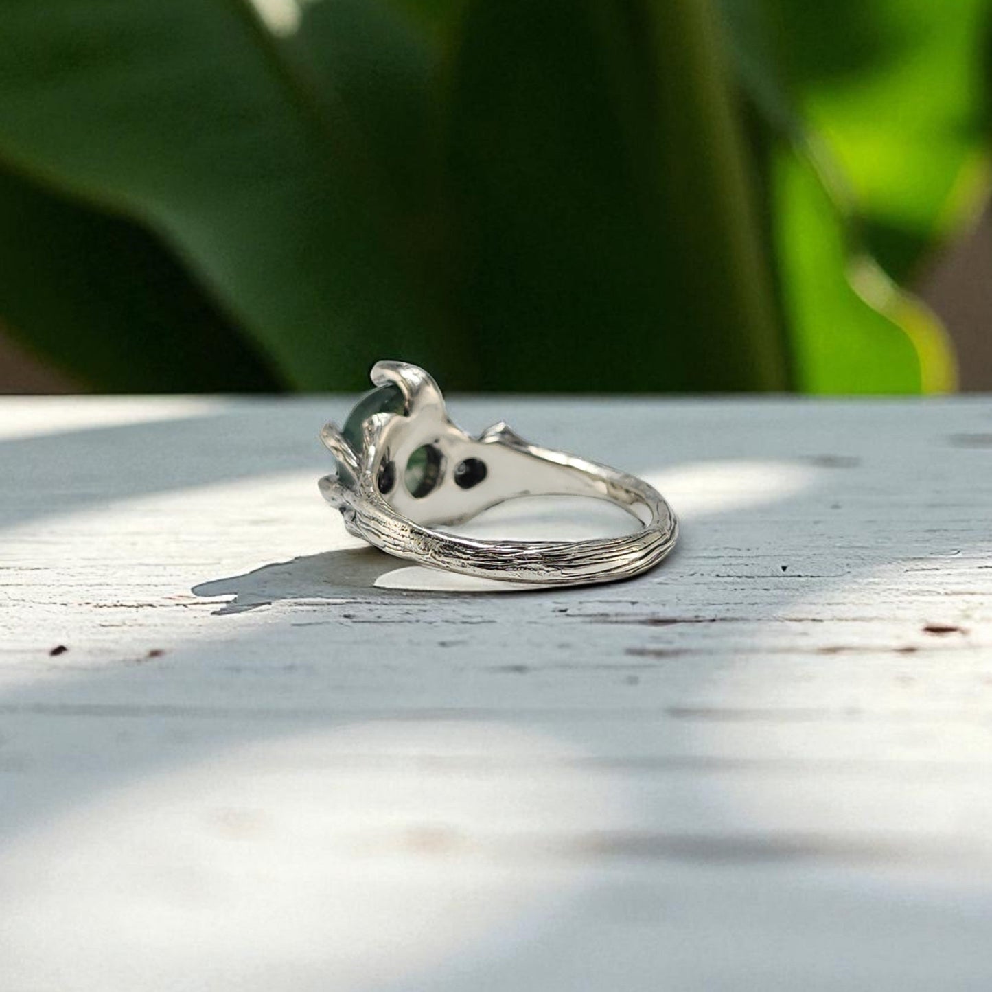 Sterling Silver ring with prongs holding an oval moss agate ring