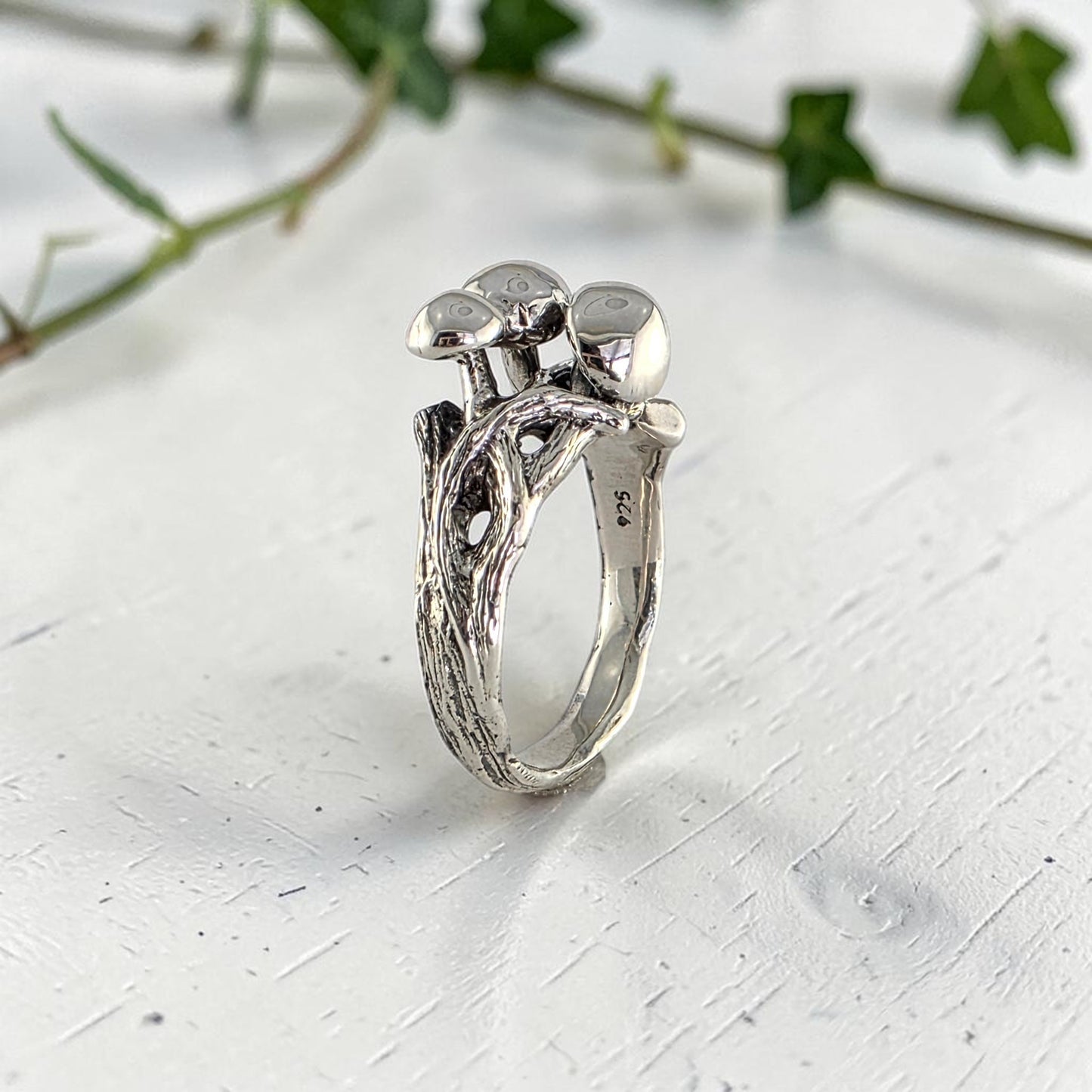 sterling silver ring with three mushrooms coming out of the top