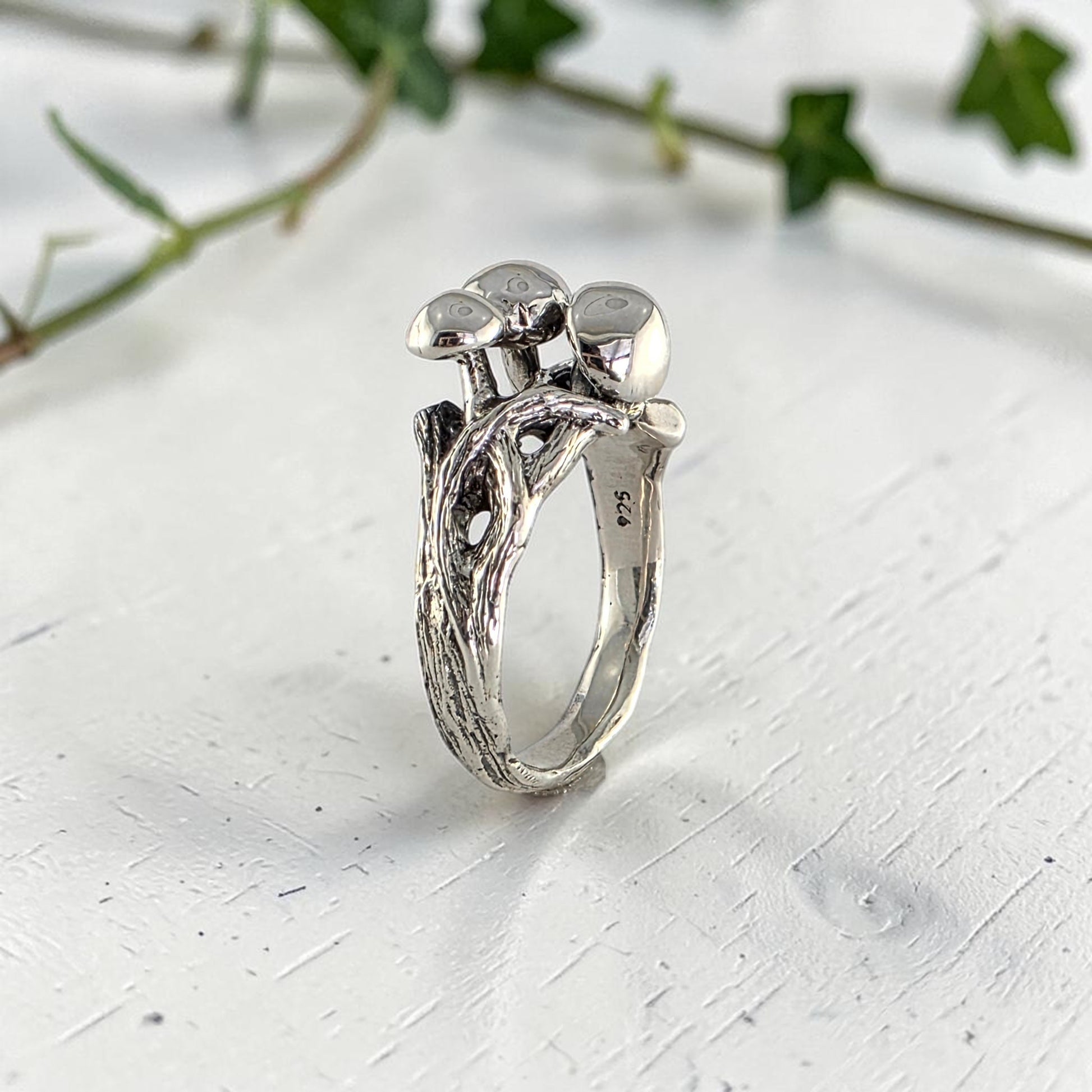 sterling silver ring with three mushrooms coming out of the top