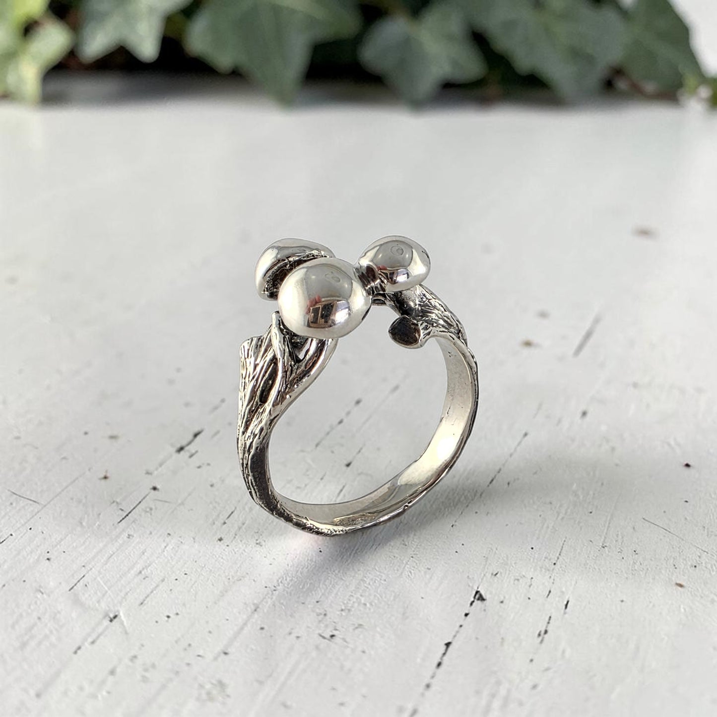 sterling silver ring with three mushrooms coming out of the top