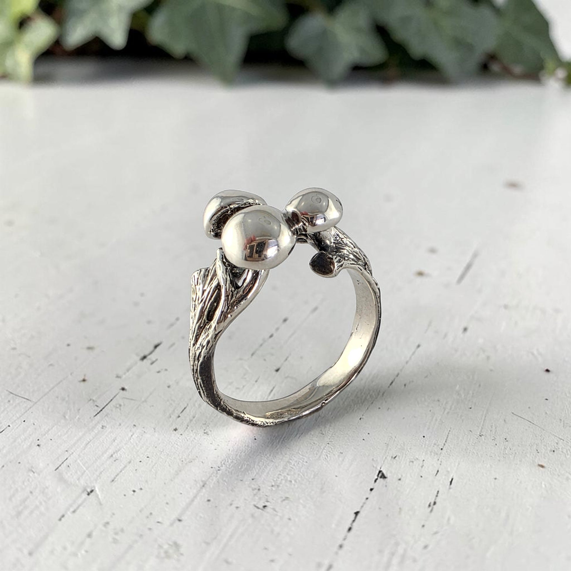 sterling silver ring with three mushrooms coming out of the top